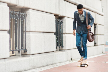 Success requires momentum, momentum requires movement. Shot of a young businessman riding a...