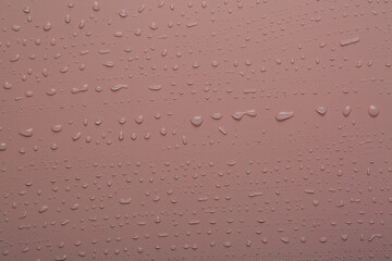 Water drops on coral  color  surface