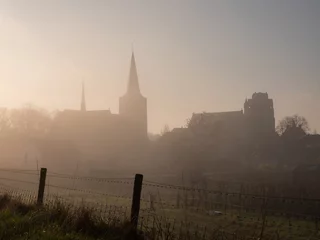 Fototapeten City Wijk bij Duurstede in the Netherlands with church on a foggy day © MyStockVideo