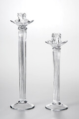 Pair of glass candle holders of different sizes, isolated