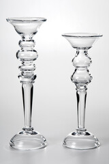 Pair of glass candle holders of different sizes, isolated