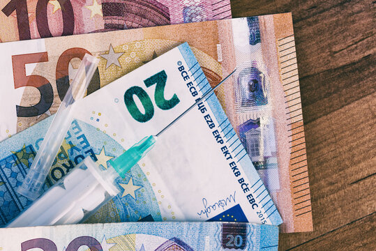 Medical vaccine with with euros paper money. Medicine and money concept. Macro close up photo