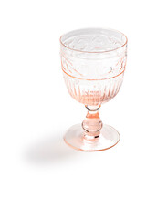 Light pink glass goblet with high relief, isolated