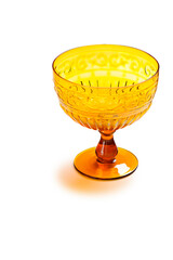 Yellow glass goblet with high relief, isolated