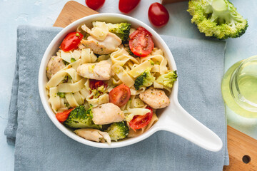 Tagliatelle pasta with chicken, broccoli, and cherry tomatoes