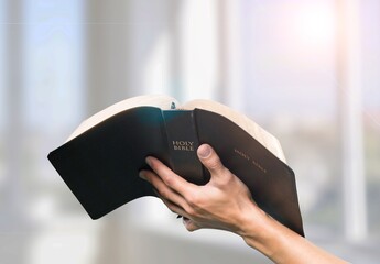 A human holding and read book with window  light, crisis solution pray to God, Christian