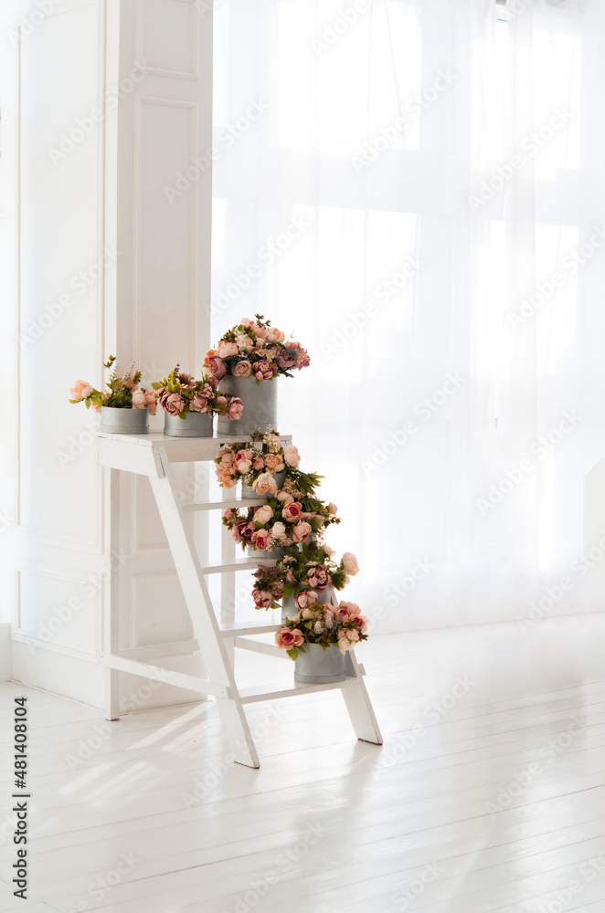 Canvas Prints Bouquets of roses on a white staircase. Interior decor.