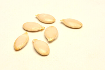 ripe pumpkin seeds on white background