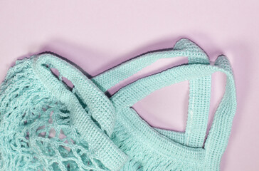 Empty mesh bag on pink background, top view. Space for text, eco-friendly shopping bag