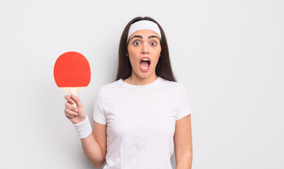 pretty hispanic woman looking very shocked or surprised. ping pong concept