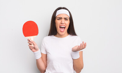 pretty hispanic woman looking desperate, frustrated and stressed. ping pong concept