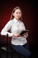 girl manager is holding a notebook and planning a working day