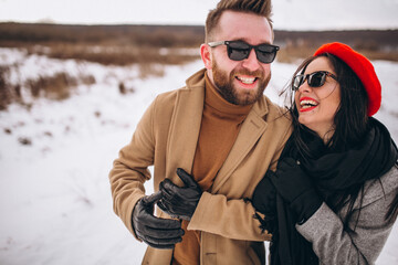 Portrait of young couple in winter park