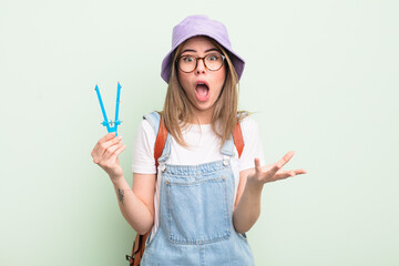 pretty young woman feeling extremely shocked and surprised. student concept