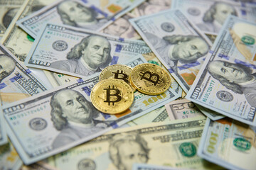 Golden bitcoin coins on a paper money dollar Virtual currency. New virtual money exchange for dollars