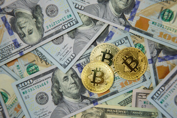 Golden bitkoyny on dollar bills. fall of bitcoin