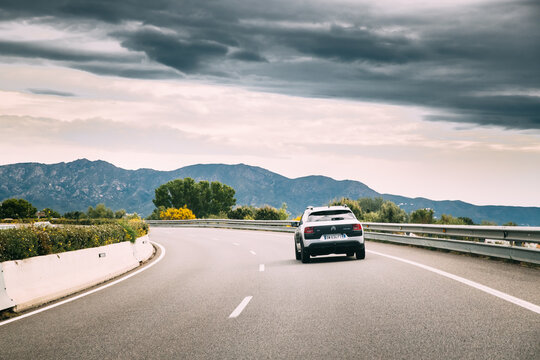 Citroen C4 Cactus Car Goes On Highway Road On Background Of Spanish Mountain Nature Landscape. C4 Cactus Is A Mini Crossover, Produced By French Automaker Citroen