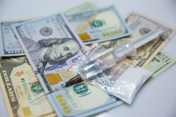The drug for the dose of drugs in a syringe against the background of doller. Drugs are against the law