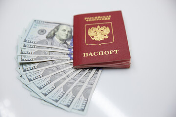 Fototapeta premium Russian passport and one hundred dollar bills