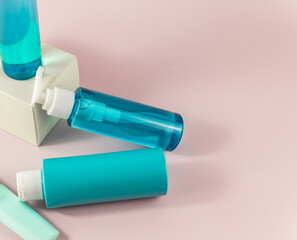 Flat lay composition with cosmetic products and accessories on a pink pastel background. Top view