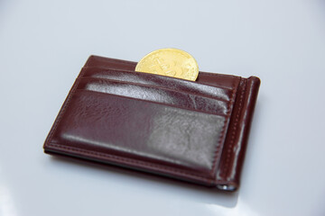 Bitcoin crypto currency in the brown wallet. Electronic money. fall of bitcoin