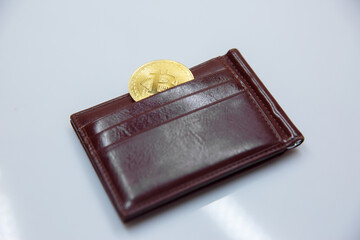 Bitcoin crypto currency in the brown wallet. Electronic money. fall of bitcoin