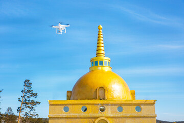 unmanned aerial vehicle with a camera in flight. quadrupter in the sky