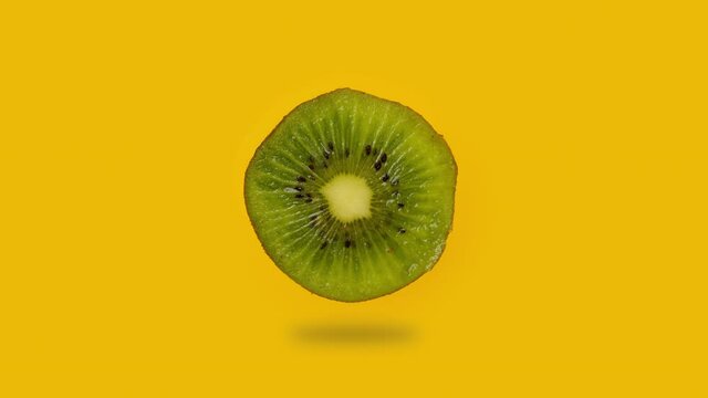 Cutting kiwi fruit into slices. Cut single kiwi. Vitamins and benefits of a fresh and tasty kiwi. Organic and Vegetarian dessert. Preparing fruits for salad.