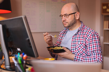 Man taking lunch break while working in home office