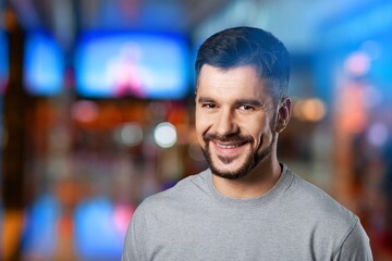 Portrait of Handsome Man Smiling, Looking at Camera, Standing in Night City with Bokeh