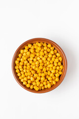 Top view of traditional Indian crispy, salty, savory snack - roasted  chickpeas, sprinkled with spices in a clay bowl isolated on a white background