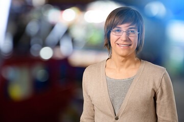 Fototapeta premium Portrait of Handsome Man Smiling, Looking at Camera, Standing in Night City with Bokeh