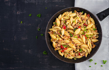 Conchiglie pasta. Italian pasta shells with minced meat, zucchini, tomato and sweet peppers. Top view, above