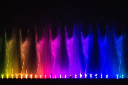  Beautiful fountain dancing show with reflection on water at night.