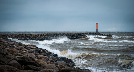 lighthouse by the sea on a windy cloudy day