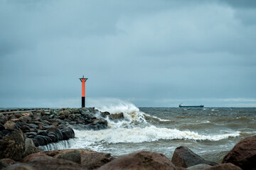 lighthouse by the sea on a windy cloudy day