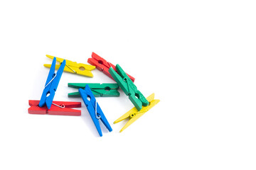 colored pegs on a white background - obrazy, fototapety, plakaty