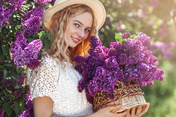 Young attractive girl outdoors. Lady with lilac bouquet. Bright female closeup portrait
