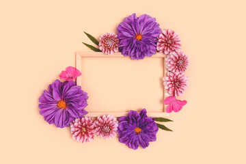 Top view of flower border frame made of dahlia on a beige background. Greeting card for 8 March with copyspace. Nature concept.