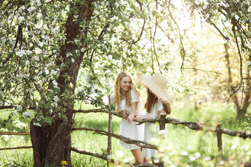 Two cute girls outdoor. Pretty sisters having fun together.