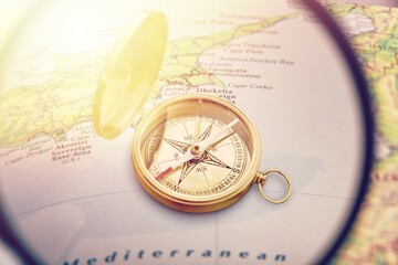 Retro style antique golden compass. Vintage still life. Sailing accessories. Wanderlust, travel