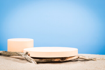 Empty round beige platform podium and dry tree twigs on white beach sand background. Minimal...