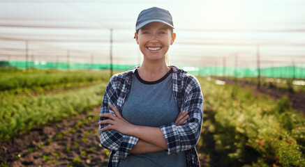 Life on the farm is awesome. Cropped portrait of an attractive young female farmer standing with...
