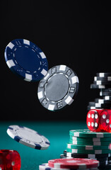 Casino Chips and Dices Flying Over Poker Green Table