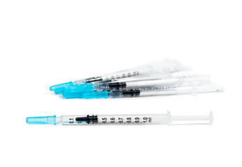 Obraz premium Group of slip tip syringes 1ml. Only one syringe in focus. Single use syringes with measuring scale. Used to measure and distribute liquid medicine to pets, infants and toddlers. Isolated on white.