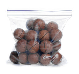 Obraz premium Macadamia nuts in pack on white background isolation
