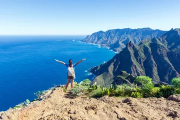 Wandcirkels Canarische Eilanden Woman hiker watching beautiful costal scenery. - Tenerife, Canary Islands, Spain. coast view, mountain Anaga  © Andrii Marushchynets