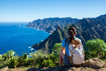 Woman hiker watching beautiful costal scenery. - Tenerife, Canary Islands, Spain. coast view, mountain Anaga © Andrii Marushchynets