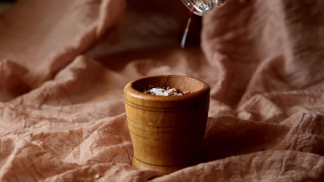 Seasoning - a mixture of pepper and coarse salt is poured into a mortar to grind the seasoning. Adds flavor to food while cooking