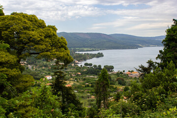 Obraz premium Landscape of Lake of Bracciano, Lazio, Italy, in a cloudy summer day